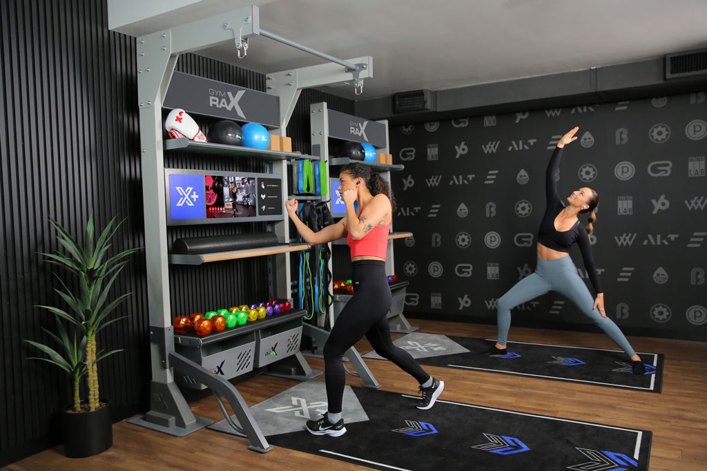 Two people working out on Xponential+ Training Bays.