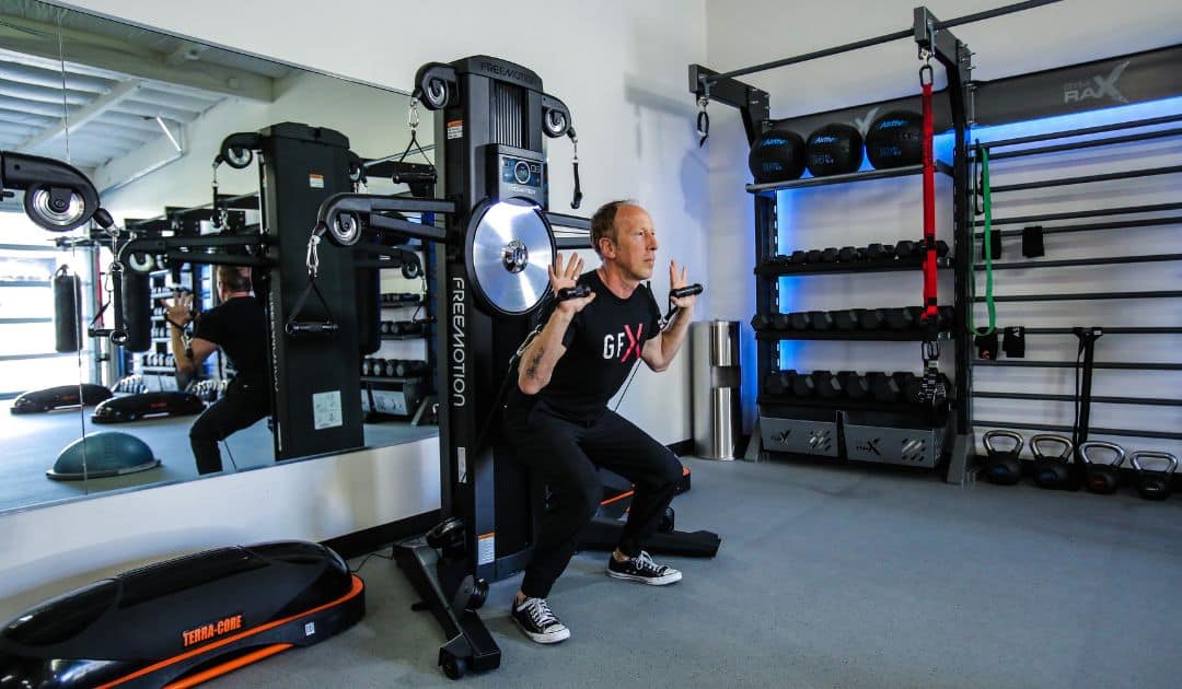 Man working out on strength training equipment.