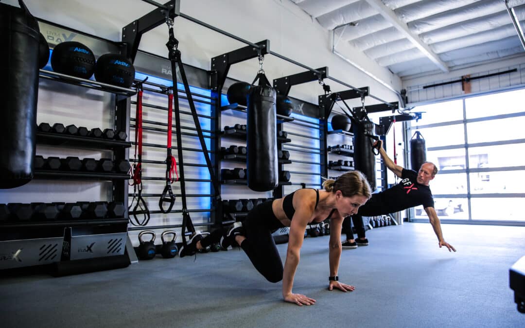 Two people in the gym working out on Gym Rax Functional Trainign Bays
